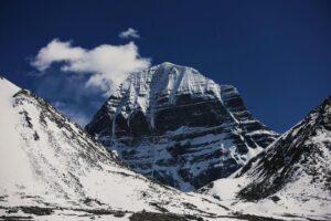 Magnificent snow-covered Mount Kailash under a clear blue sky, captured during winter.