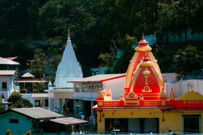 Temples with vibrant colors stand against lush greenery.