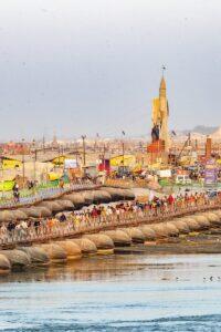 Pilgrims cross a temporary bridge during a religious event.