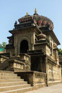 Intricate stone carvings on the ancient temple in Maheshwar, showcasing Indian heritage.