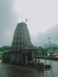 Amruteshwar Temple captured with a misty monsoon backdrop, showcasing Indian historical architecture.